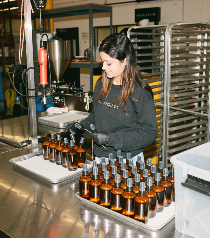 Image of women bottling perfume in bottles
